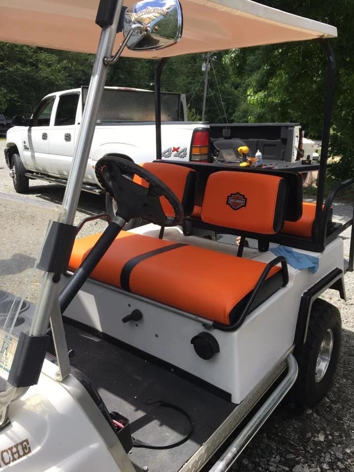 Custom Harley-Davidson golf cart with orange leather seats