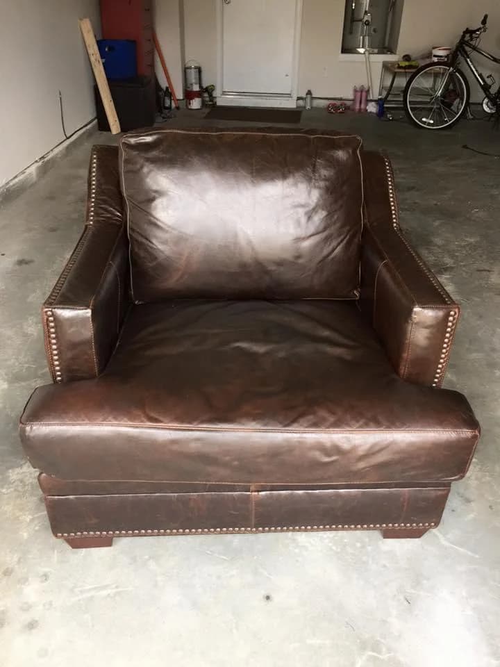 Restored brown leather club chair with nailhead trim