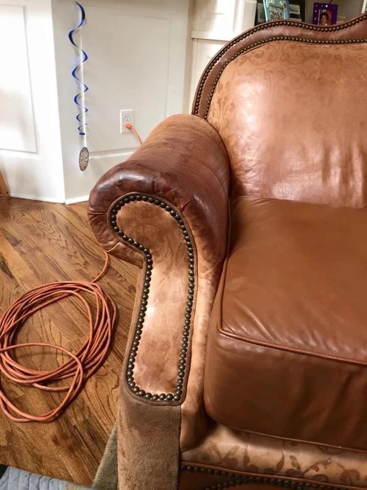 Cognac leather chair arm detail with nailhead trim